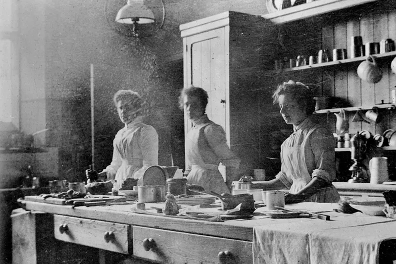 A 19th-century photograph of three kitchen maids at work.